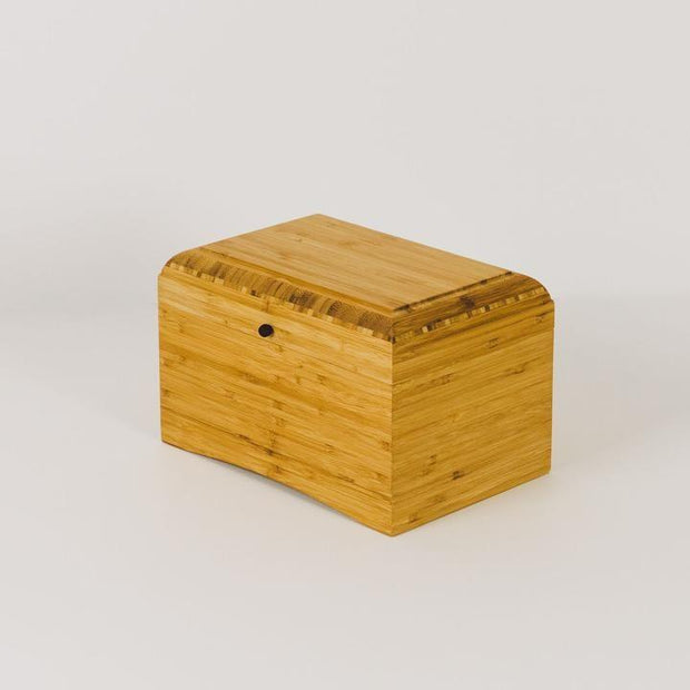 Living Urn | product image of wooden urn at home. Sustainable bamboo urns for people and pets.