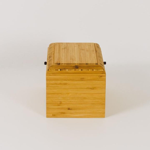 Living Urn | Product image of wooden urn at home. Sustainable bamboo urns for people and pets.
